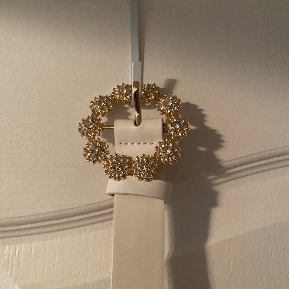 Bedazzled belt buckle with white belt